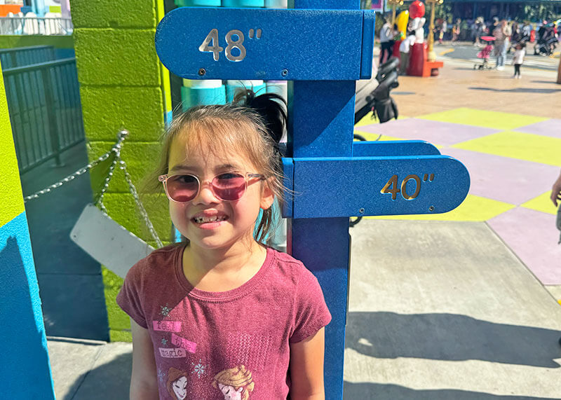 Your Guide to LEGOLAND California Height Requirements and Rider Swap Service - Girl being measured