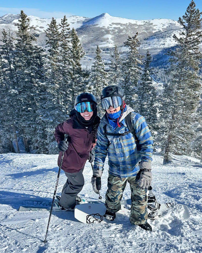 All the Details of the Epic Pass - Two friends skiing and boarding together