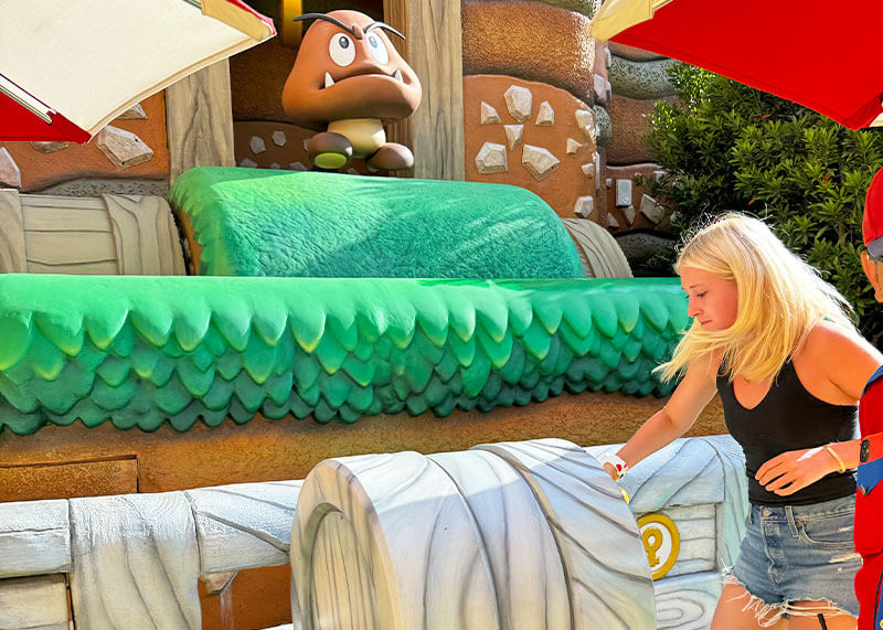 How to Manage Summer Crowds and Heat at Universal Studios Hollywood - Girl turns crank in Super Nintendo World game