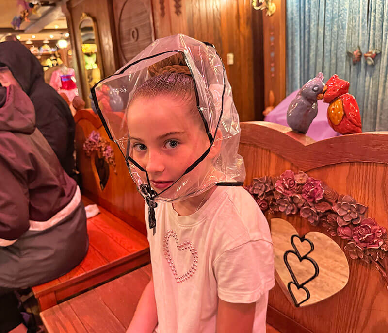 Essential Disneyland Rainy Day Tips - Girl with head covering at Bibbidi Bobbidi Boutique