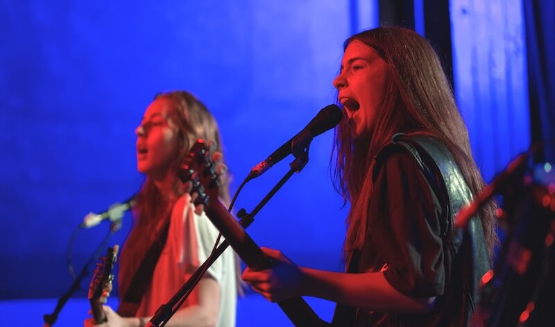 HAIM tour 2025 - HAIM performing on stage