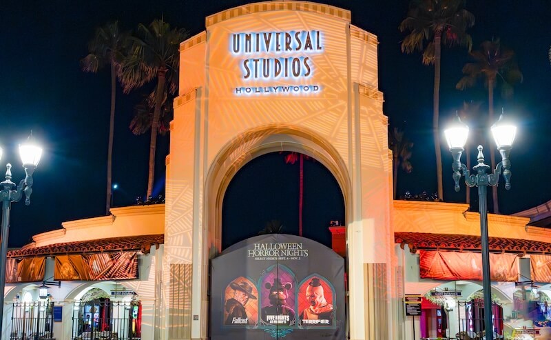 Universal Studios Hollywood main archway with Halloween Horror Nights signage on gate heroing Five Nights at Freddy's, Fallout and Terrifier