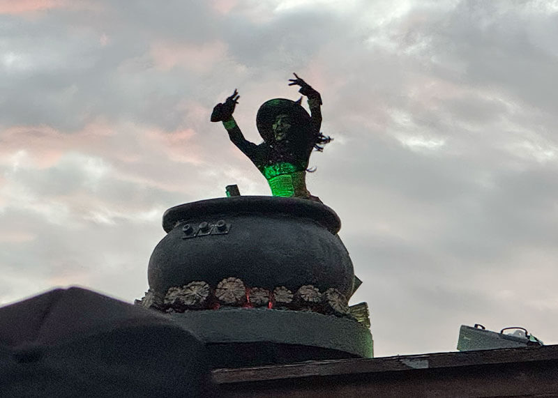Your Ghoulish Guide to Knott’s Scary Farm - Green Witch in Opening Scaremoney