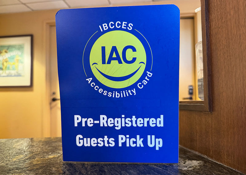 Overview of the Universal Studios Hollywood Attraction Assistance Pass (AAP) - IAC IBCESS pick-up sign