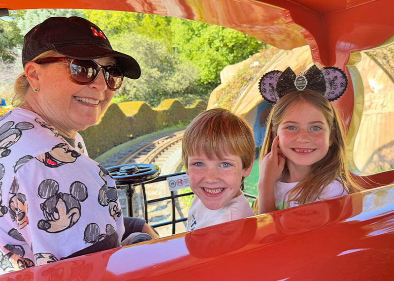 Cheapest Days to Visit Disneyland - Grandmother rides Casey Jr with grandkids