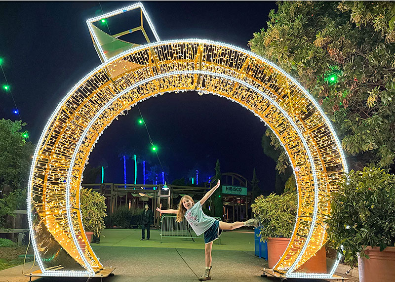 The Jolly Details of the SeaWorld San Diego Christmas Celebration- Kid posing in giant ornament