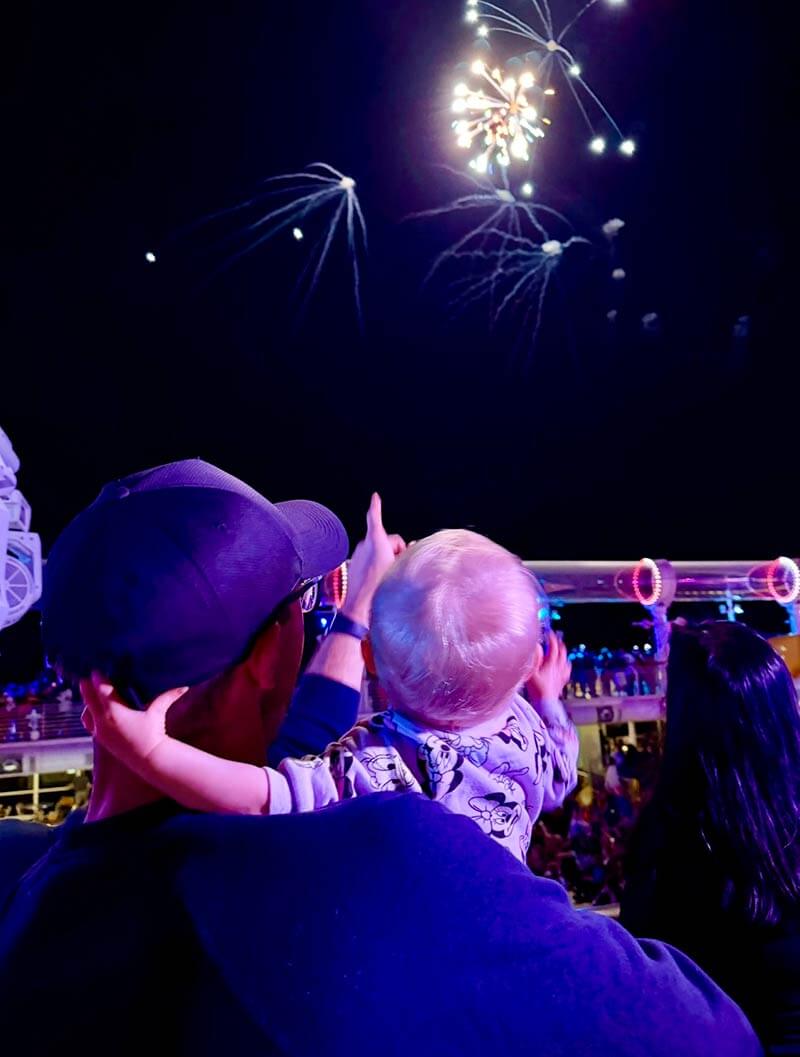 disney cruise with a baby - baby and dad watching fireworks
