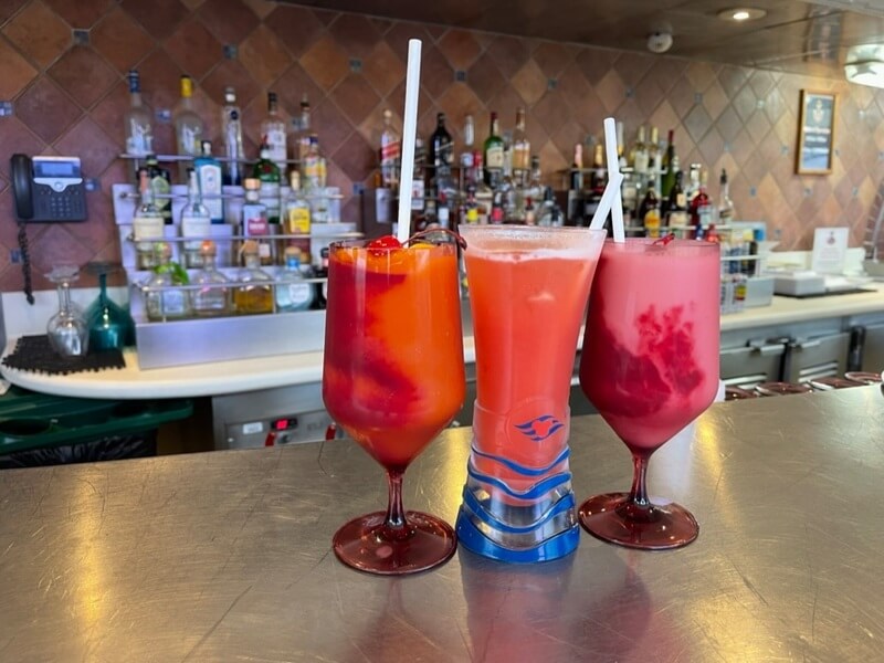 Disney Magic Restaurants - Three cocktails sit atop a bar