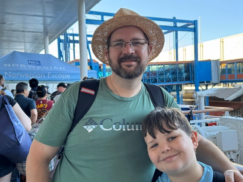 Cruises from New Orleans - Dad and son stand on the deck of a Norwegian Cruise Ship