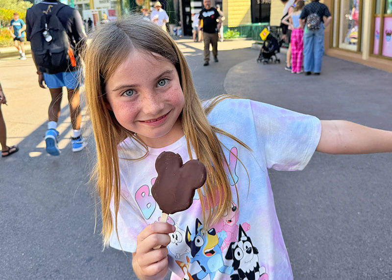 A Complete Guide to the Downtown Disney District at Disneyland - Girl with Mickey bar