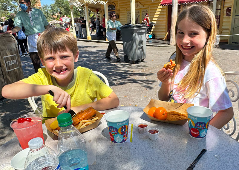 Top Disneyland Kids Meals - Kids eating adult portions of fish and chop and chicken tenders at Stage Door Cafe